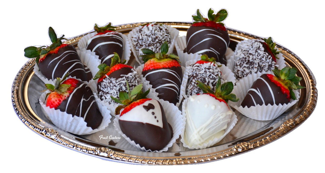 platter of coconut chocolate dipped strawberries, white swizzled strawberries, and 1 tuxedo strawberry and 1 white chocolate bride strawberry