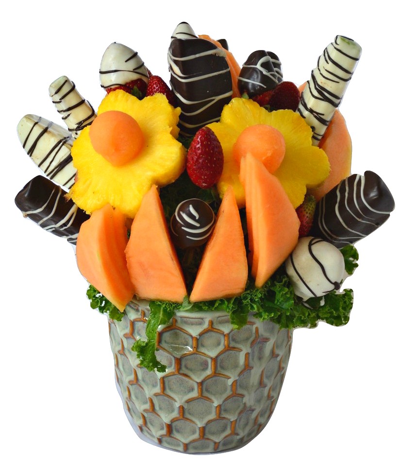 mixed fruit including pineapple shaped flowers, cantaloupe wedges, chocolate covered strawberries and apples that are artfully arranged in a vase.